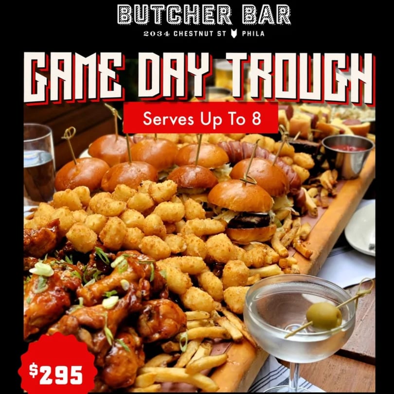 Butcher Bar's "Game Day Trough" with sliders, tater tots, wings, fries, and a martini.